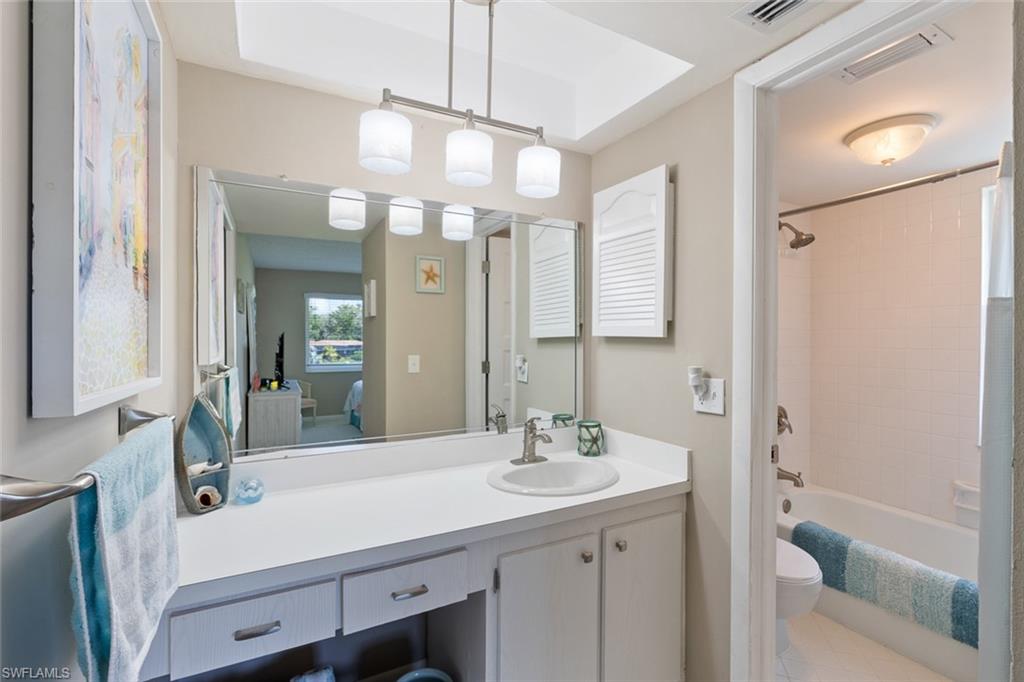 159 Quails Nest Road, Unit 1084 Naples, FL 34112 - Photo 10 of 21 a bathroom with a sink a toilet and shower