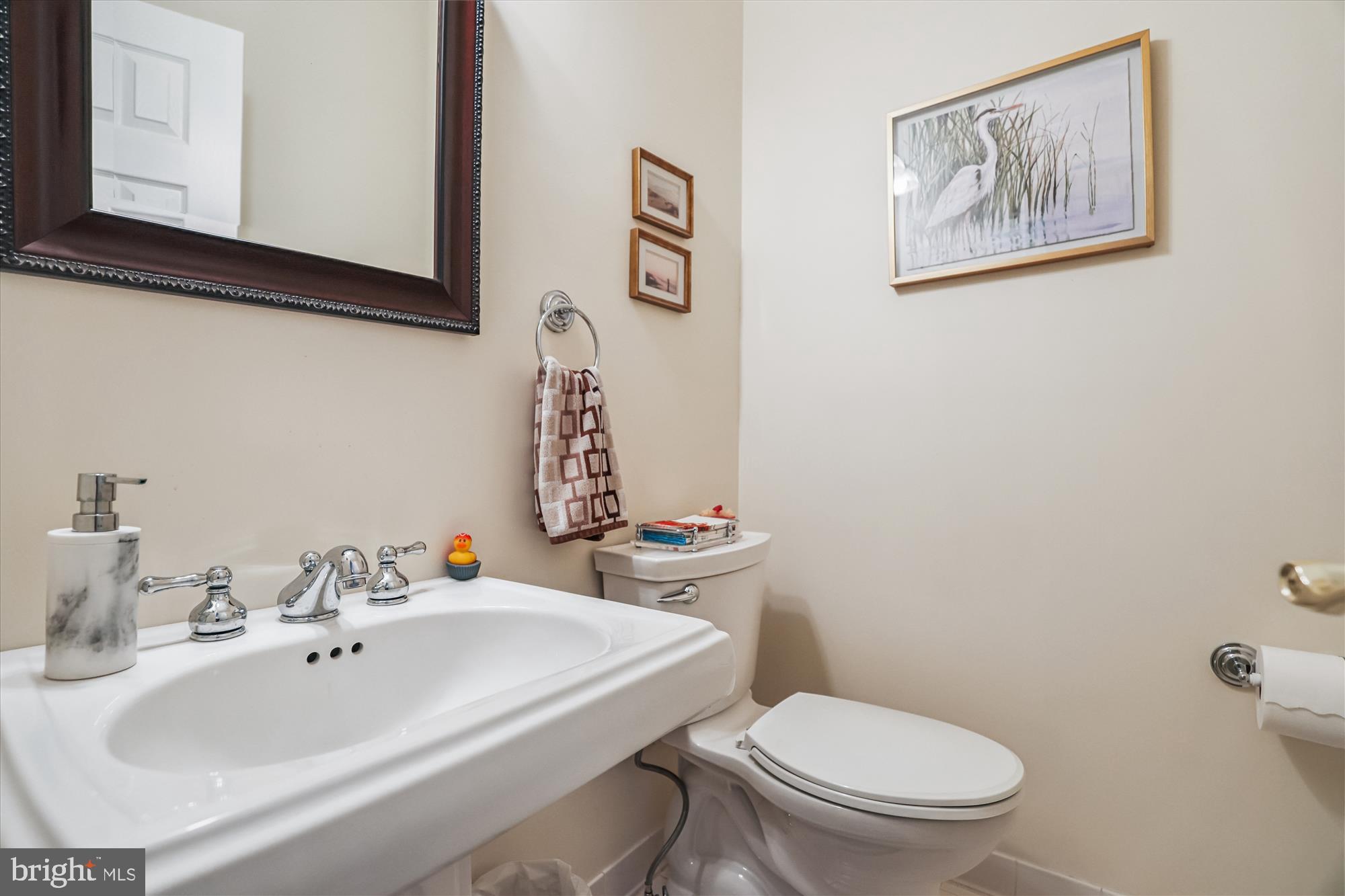 20679 Riptide Square Sterling, VA 20165 - Photo 18 of 43 a bathroom with a sink mirror and toilet