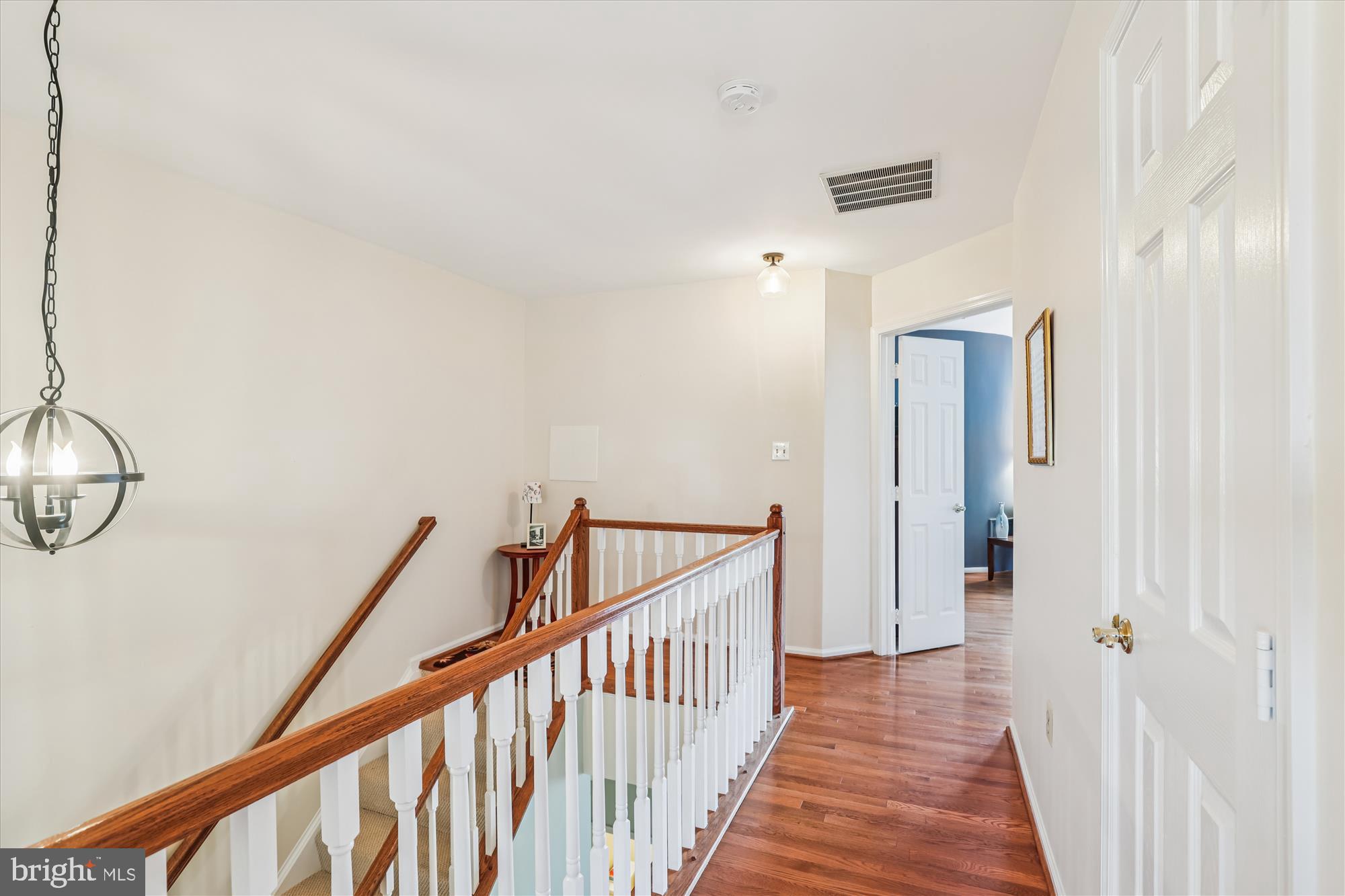 20679 Riptide Square Sterling, VA 20165 - Photo 19 of 43 a view of a hallway with wooden floor and staircase