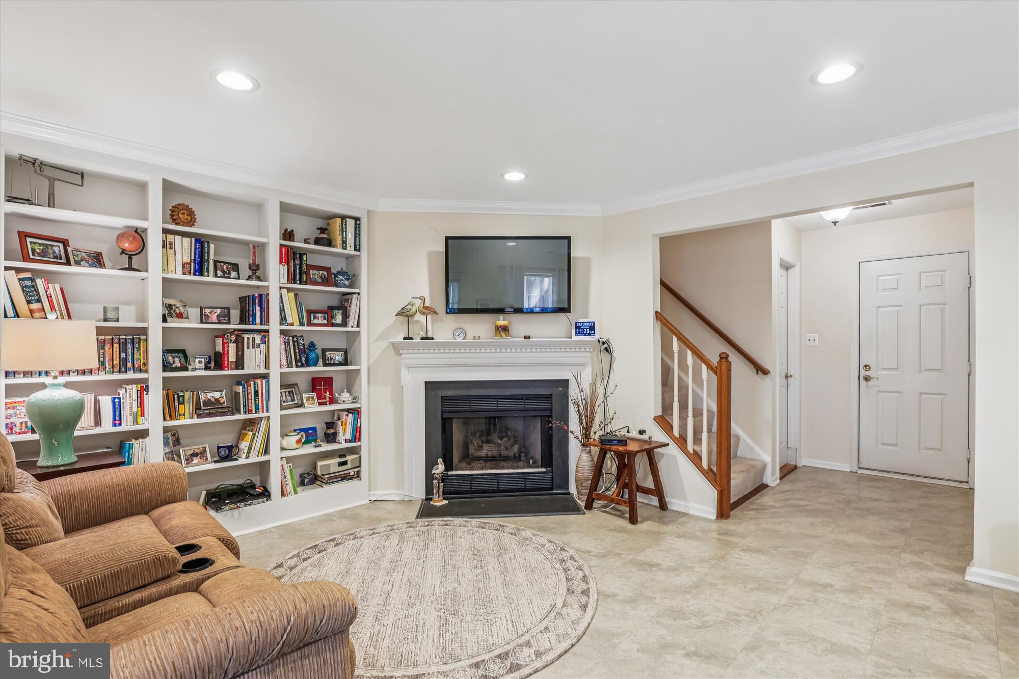 20679 Riptide Square Sterling, VA 20165 - Photo 36 of 43 a living room with furniture a fireplace and a flat screen tv