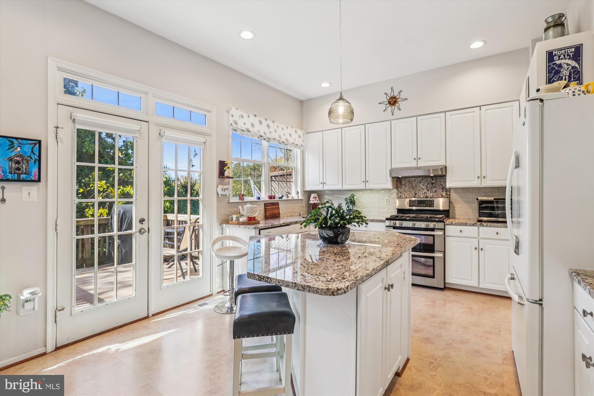20679 Riptide Square Sterling, VA 20165 - Photo 10 of 43 a kitchen with white cabinets and appliances