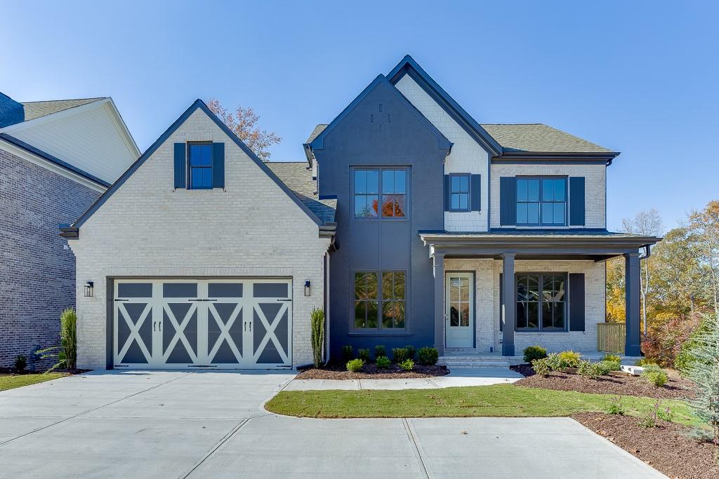 a front view of a house with yard and green space
