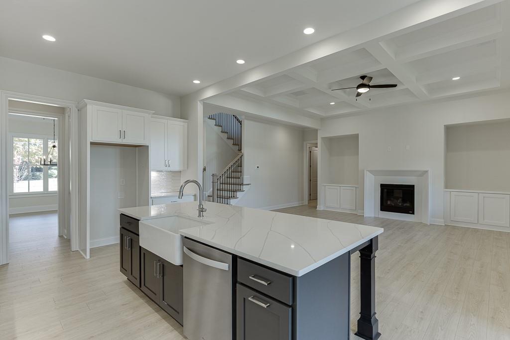 454 Thunder Road Buford, GA 30518 - Photo 19 of 78 a view of kitchen island with sink refrigerator and microwave