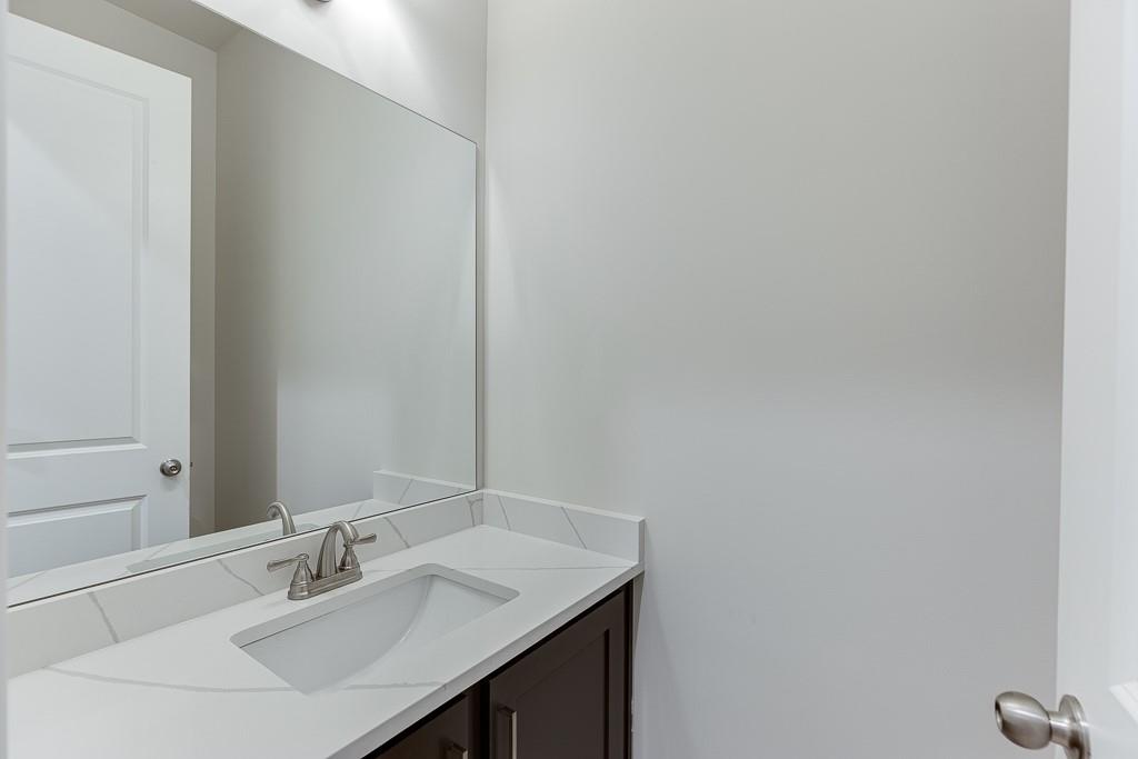 454 Thunder Road Buford, GA 30518 - Photo 24 of 78 a bathroom with a sink and a mirror