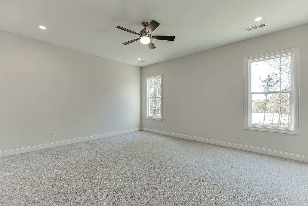 454 Thunder Road Buford, GA 30518 - Photo 26 of 78 an empty room with a window and a fan