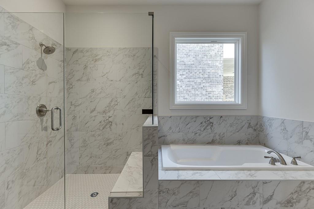 454 Thunder Road Buford, GA 30518 - Photo 30 of 78 a bath tub sitting next to a window