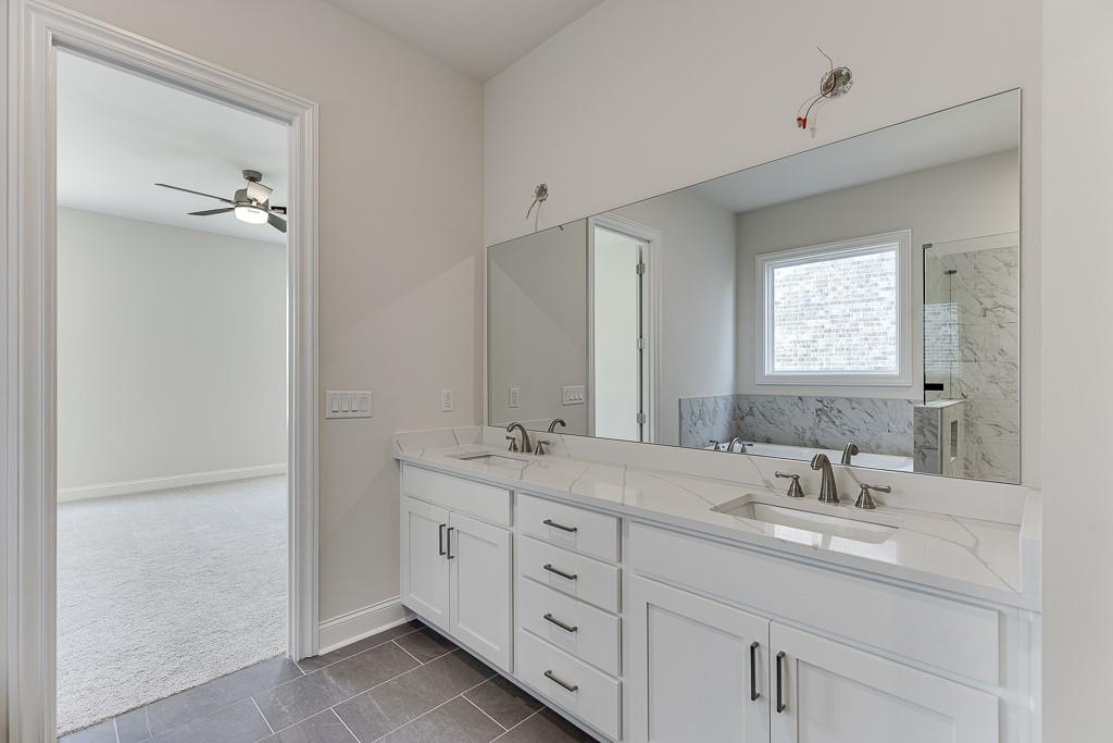 454 Thunder Road Buford, GA 30518 - Photo 31 of 78 a bathroom with double sink and a mirror