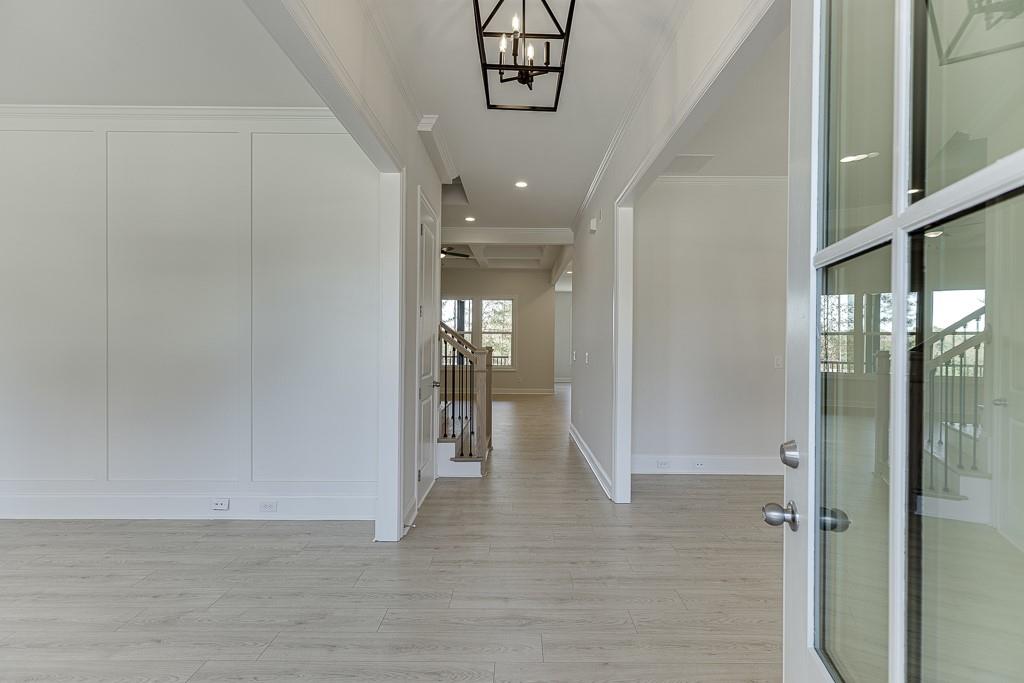 454 Thunder Road Buford, GA 30518 - Photo 4 of 78 a view of a hallway with wooden floor and a living room