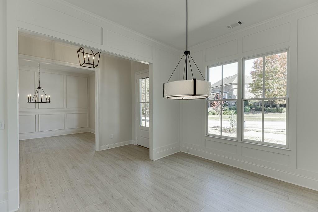 454 Thunder Road Buford, GA 30518 - Photo 7 of 78 a view of empty room with wooden floor and fan