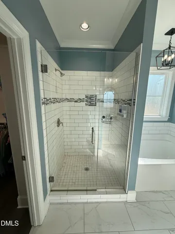 a bathroom with a glass door shower