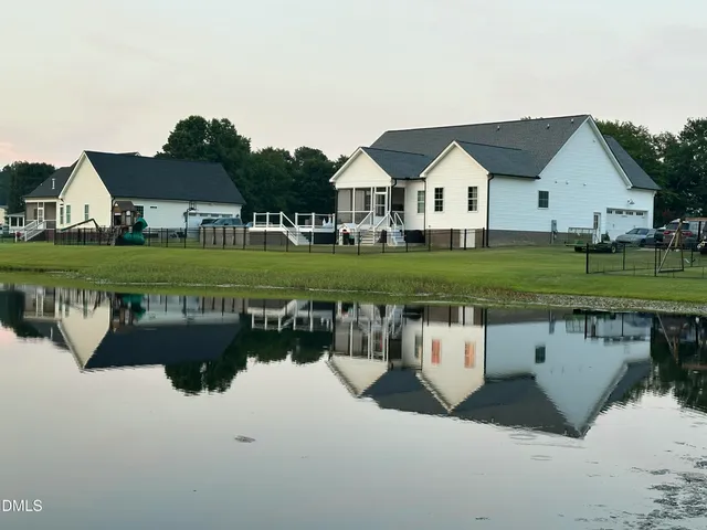 a view of house with garden and deck