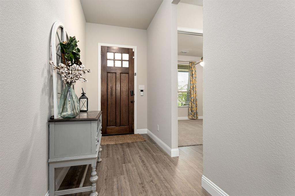 1320 Rosebush Road Aubrey, TX 76227 - Photo 7 of 33 a view of a hallway with wooden floor and staircase