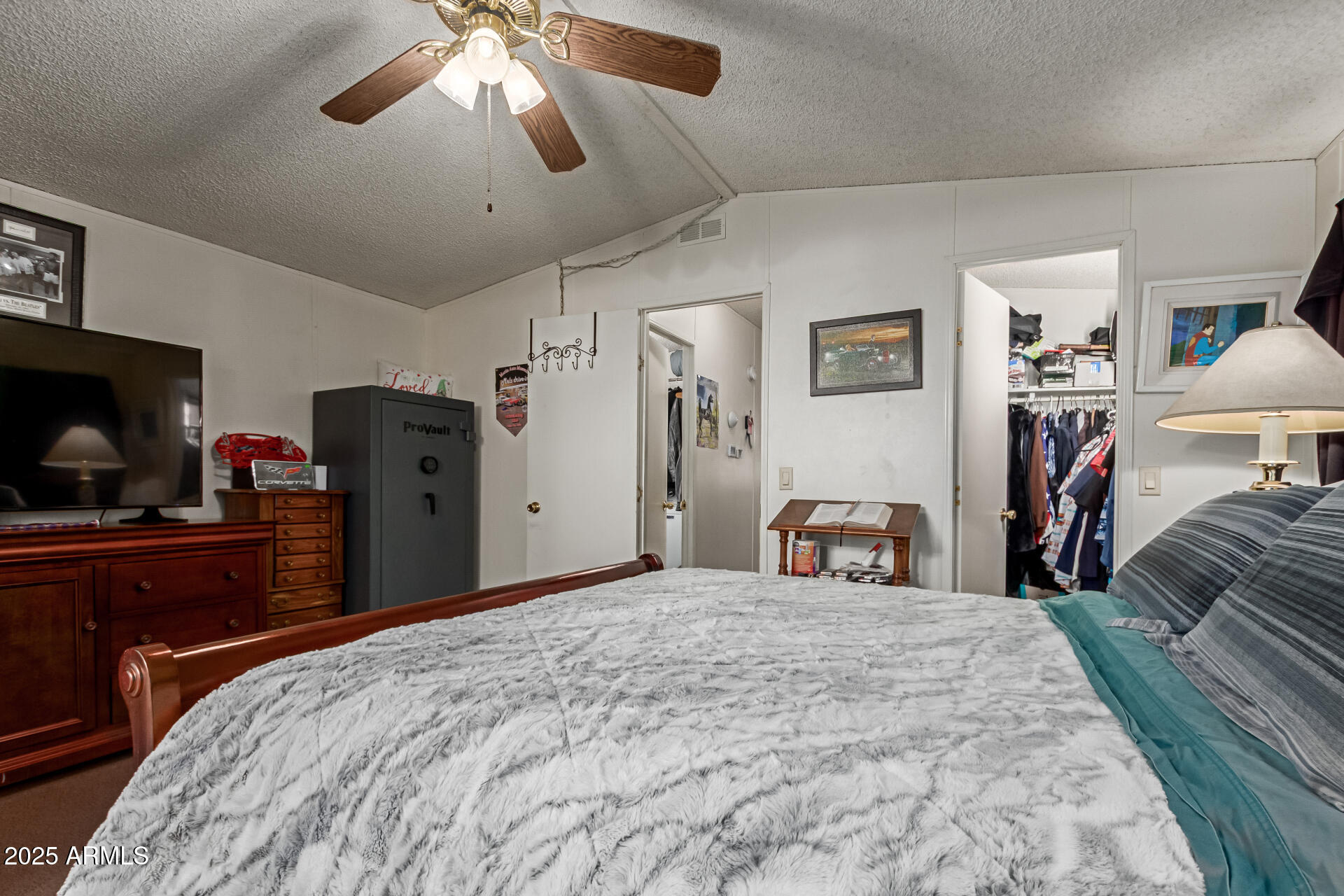 1221 North Dysart Road, Unit 42 Avondale, AZ 85323 - Photo 12 of 23 a bedroom with a bed and a chandelier