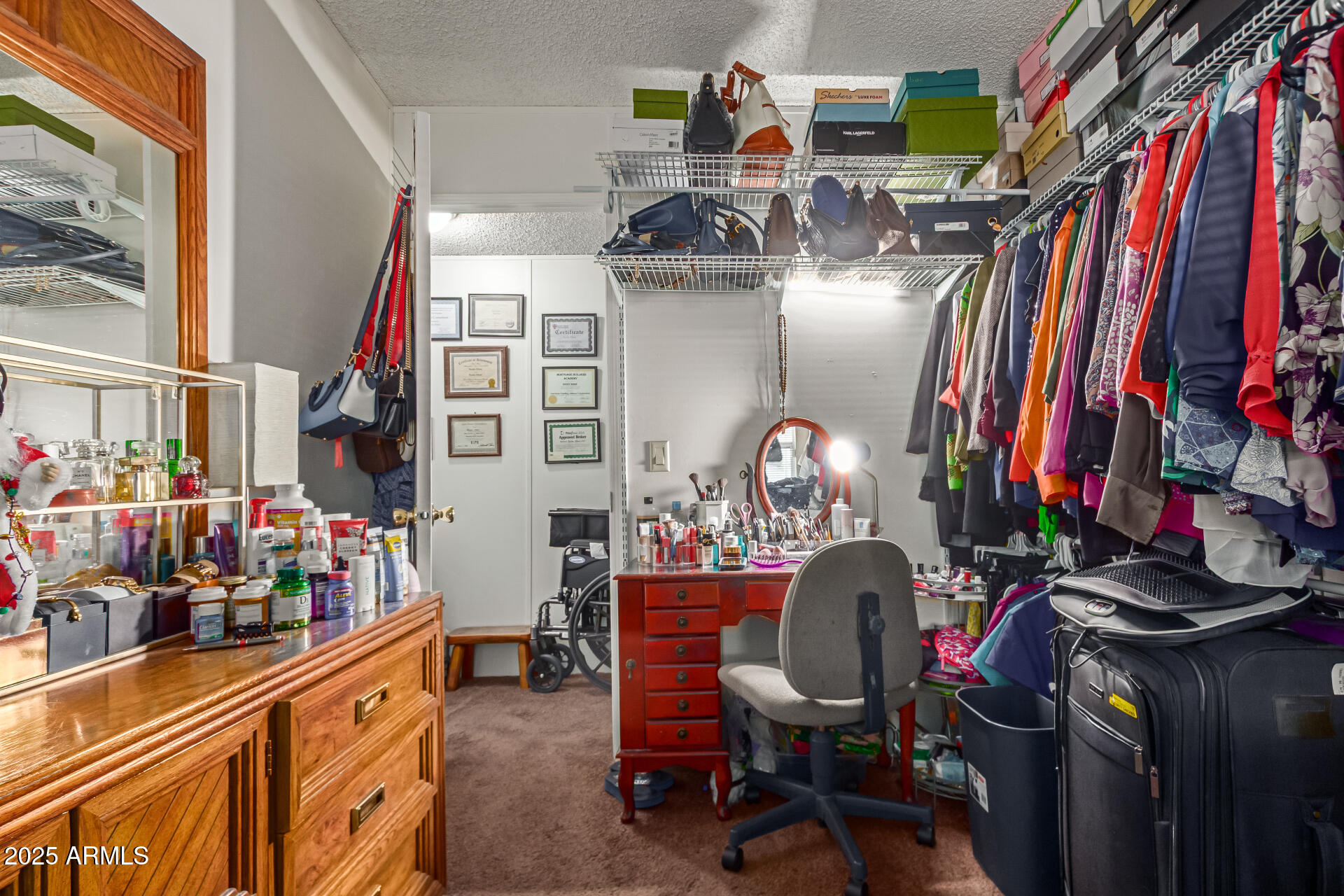 1221 North Dysart Road, Unit 42 Avondale, AZ 85323 - Photo 17 of 23 a view of walk in closet with clothes and shoes