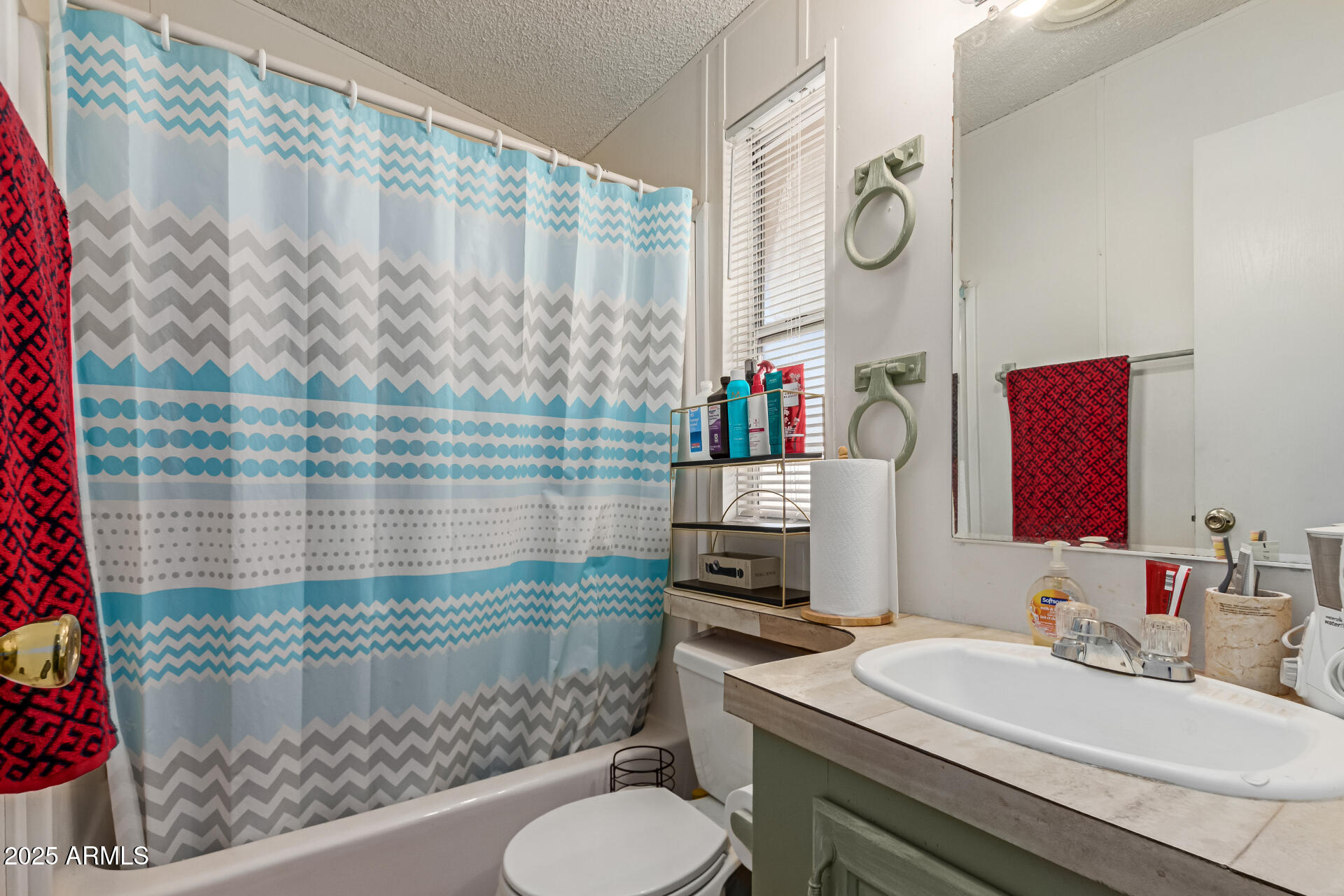 1221 North Dysart Road, Unit 42 Avondale, AZ 85323 - Photo 19 of 23 a bathroom with a sink toilet vanity and shower