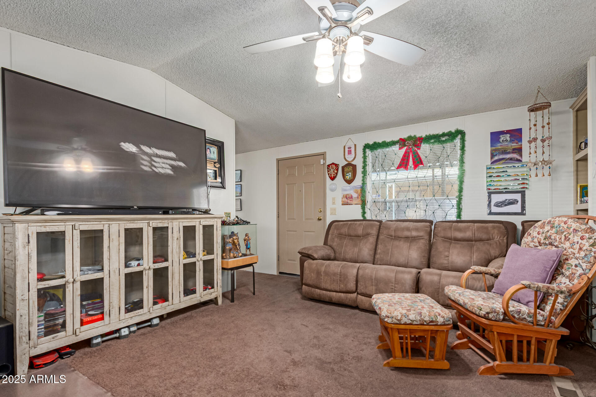 1221 North Dysart Road, Unit 42 Avondale, AZ 85323 - Photo 5 of 23 a bedroom with furniture and a flat screen tv