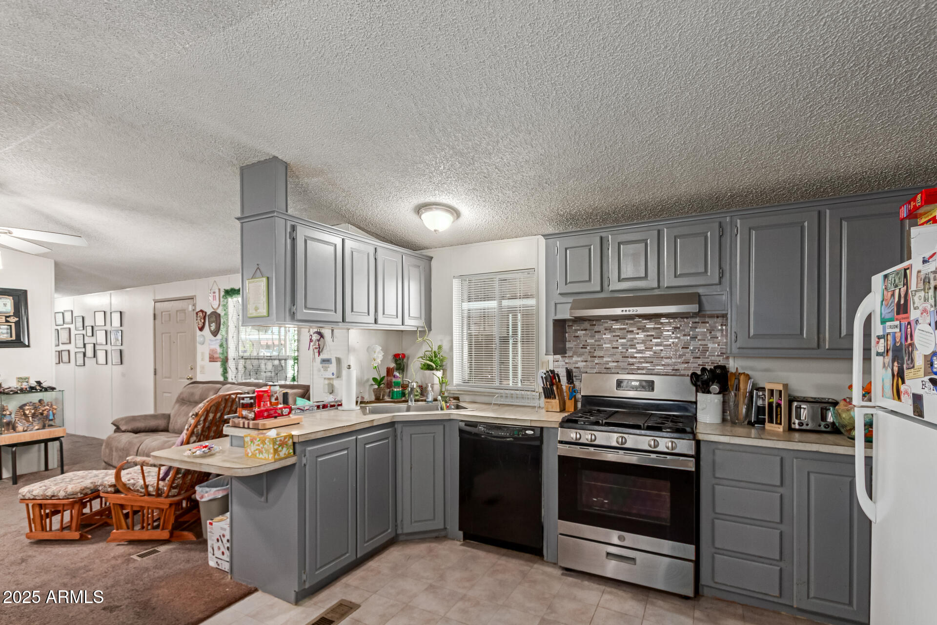 1221 North Dysart Road, Unit 42 Avondale, AZ 85323 - Photo 7 of 23 a kitchen with a sink stove and cabinets