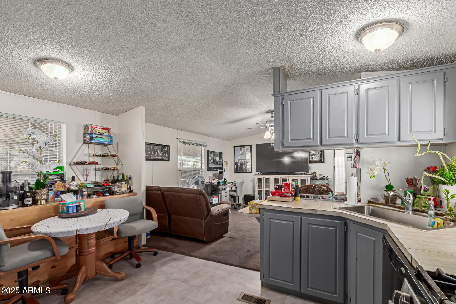 1221 North Dysart Road, Unit 42 Avondale, AZ 85323 - Photo 8 of 23 a living room with furniture and a kitchen view