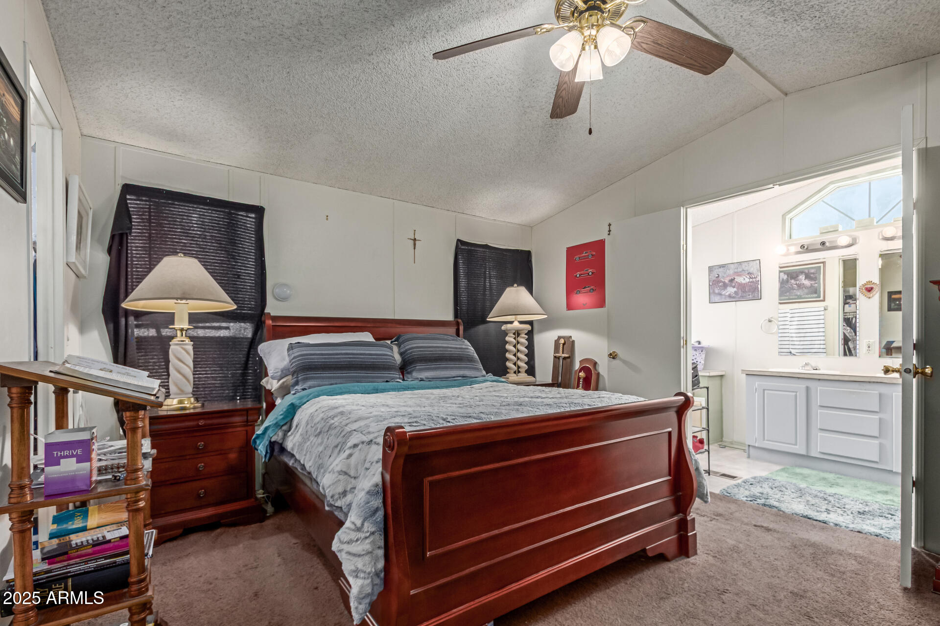 1221 North Dysart Road, Unit 42 Avondale, AZ 85323 - Photo 10 of 23 a bed room with a bed and a chandelier
