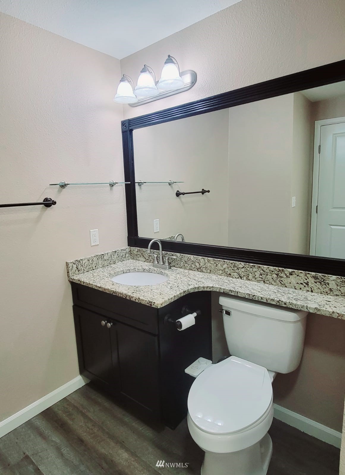 10813 Northeast 147th Lane, Unit N102 Bothell, WA 98011 - Photo 15 of 25 a bathroom with a granite countertop toilet sink and mirror