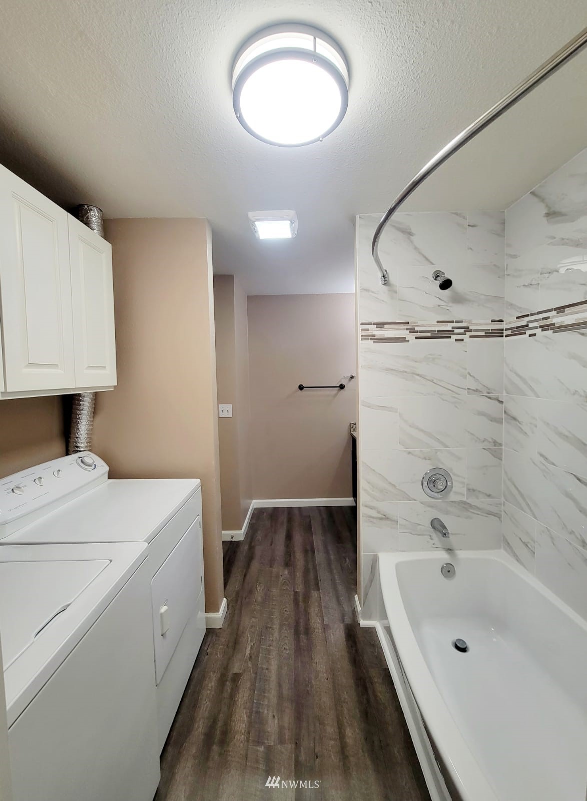 10813 Northeast 147th Lane, Unit N102 Bothell, WA 98011 - Photo 16 of 25 a bathroom with a sink a toilet and bathtub