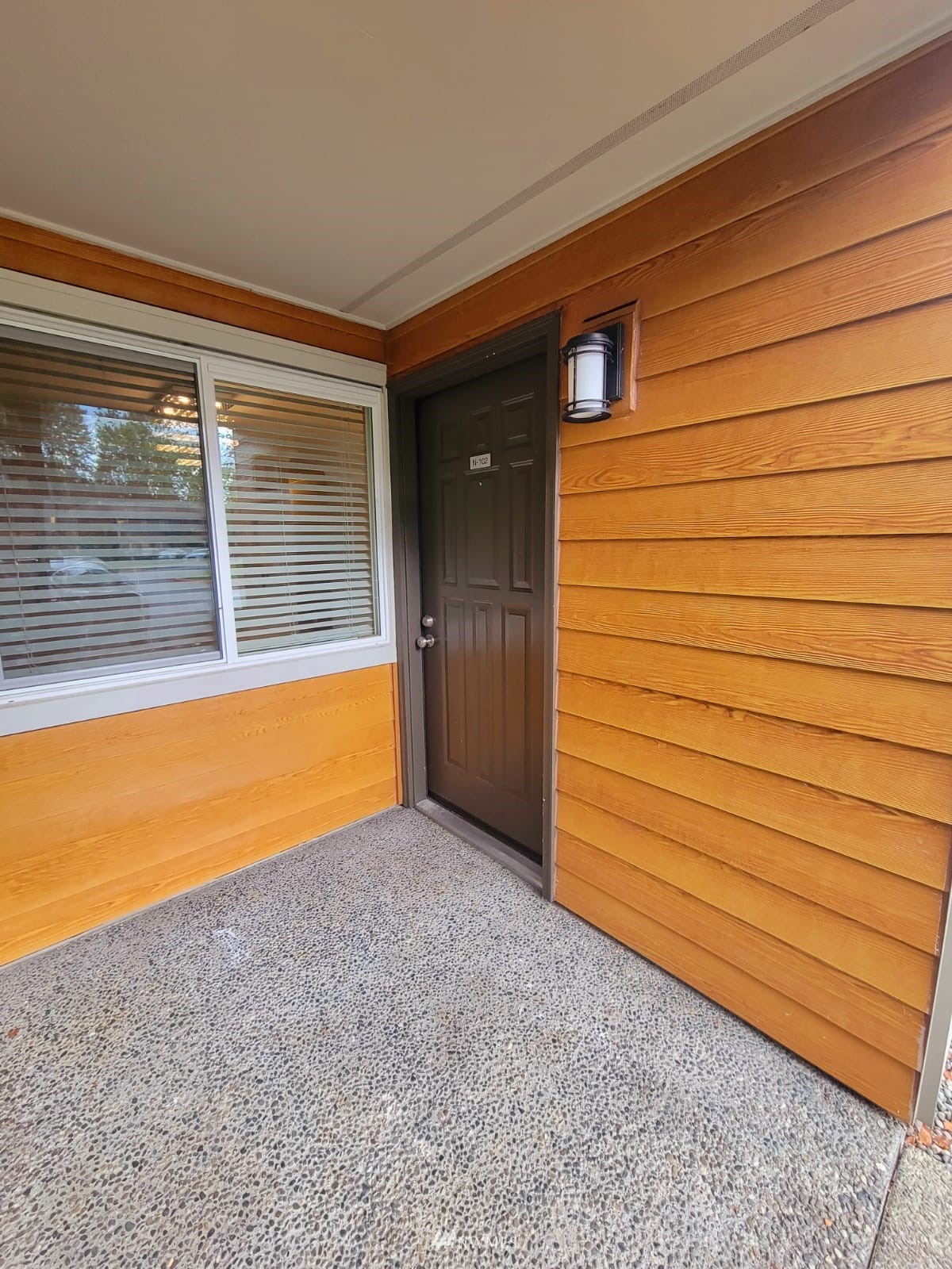 10813 Northeast 147th Lane, Unit N102 Bothell, WA 98011 - Photo 4 of 25 a view of front door and wooden floor