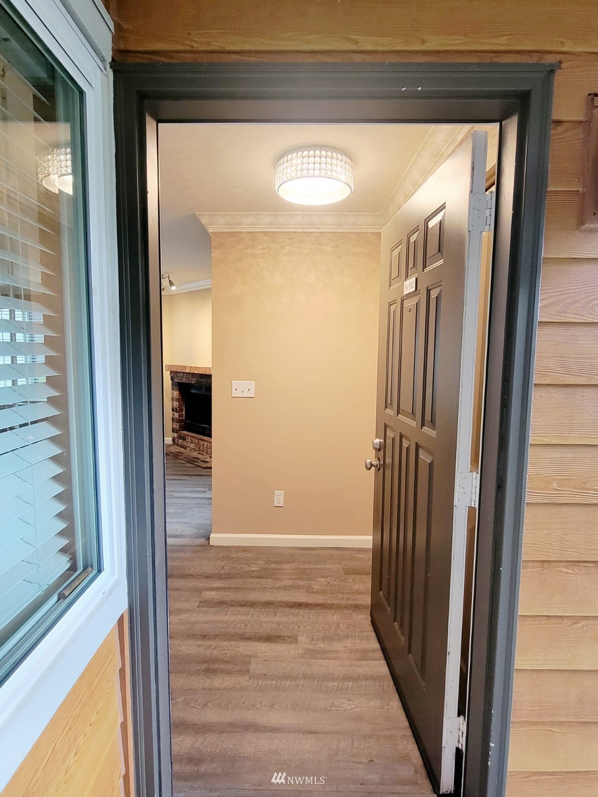 10813 Northeast 147th Lane, Unit N102 Bothell, WA 98011 - Photo 5 of 25 a view of a hallway with wooden floor and staircase