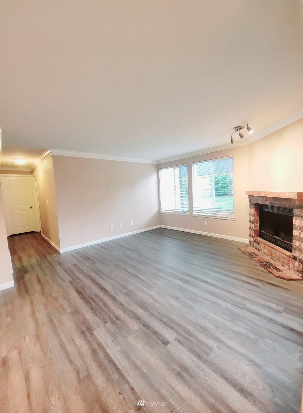 10813 Northeast 147th Lane, Unit N102 Bothell, WA 98011 - Photo 9 of 25 a view of empty room with wooden floor and fan