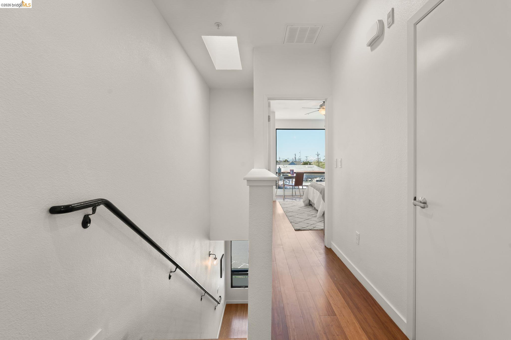 1780 12th Street Oakland, CA 94607 - Photo 15 of 31 a view of a hallway with wooden floor and staircase