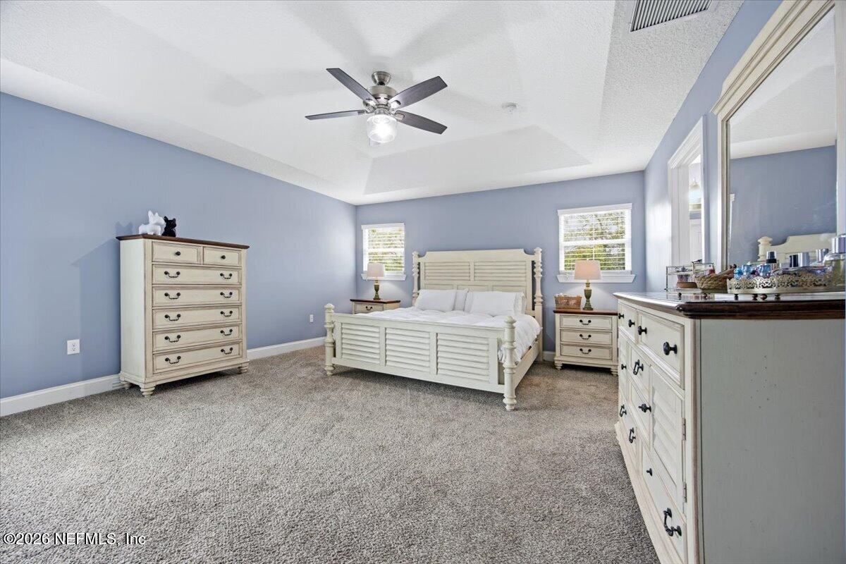 4009 Palm Way Jacksonville Beach, FL 32250 - Photo 13 of 24 a bedroom with a bed and a chandelier
