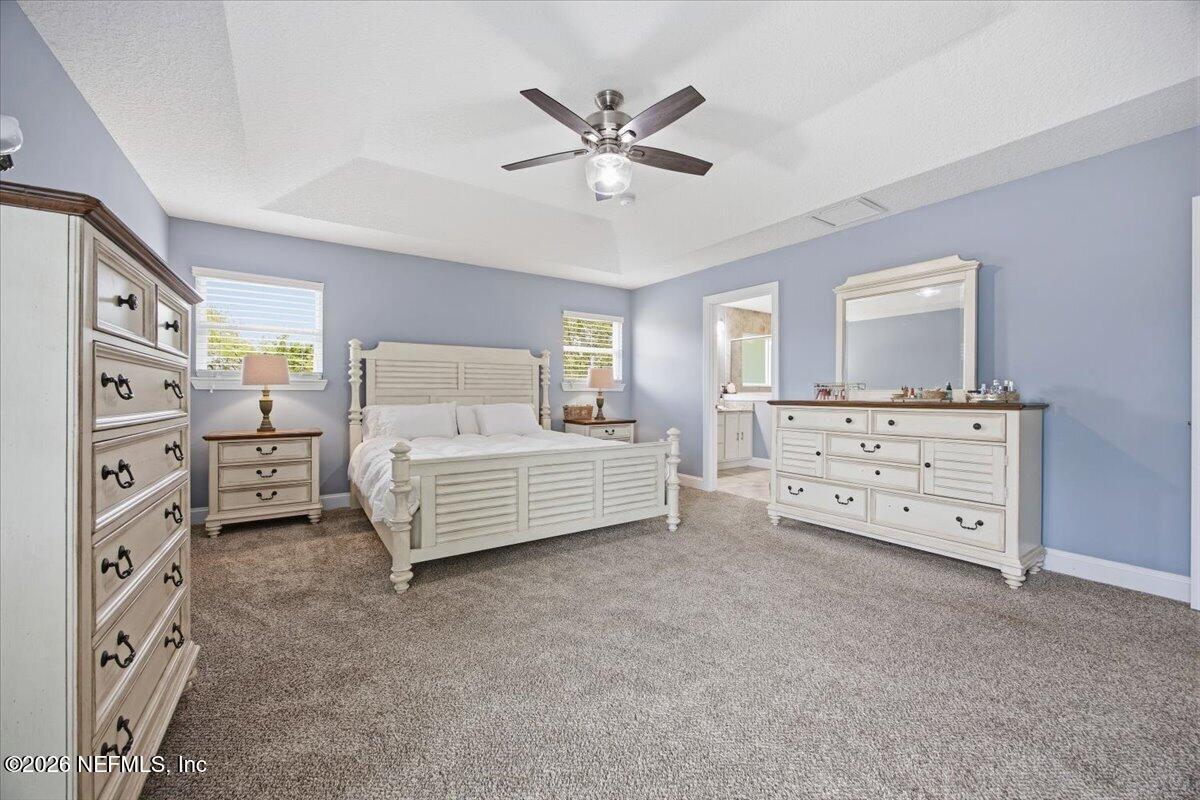4009 Palm Way Jacksonville Beach, FL 32250 - Photo 14 of 24 a bedroom with a bed and a chandelier