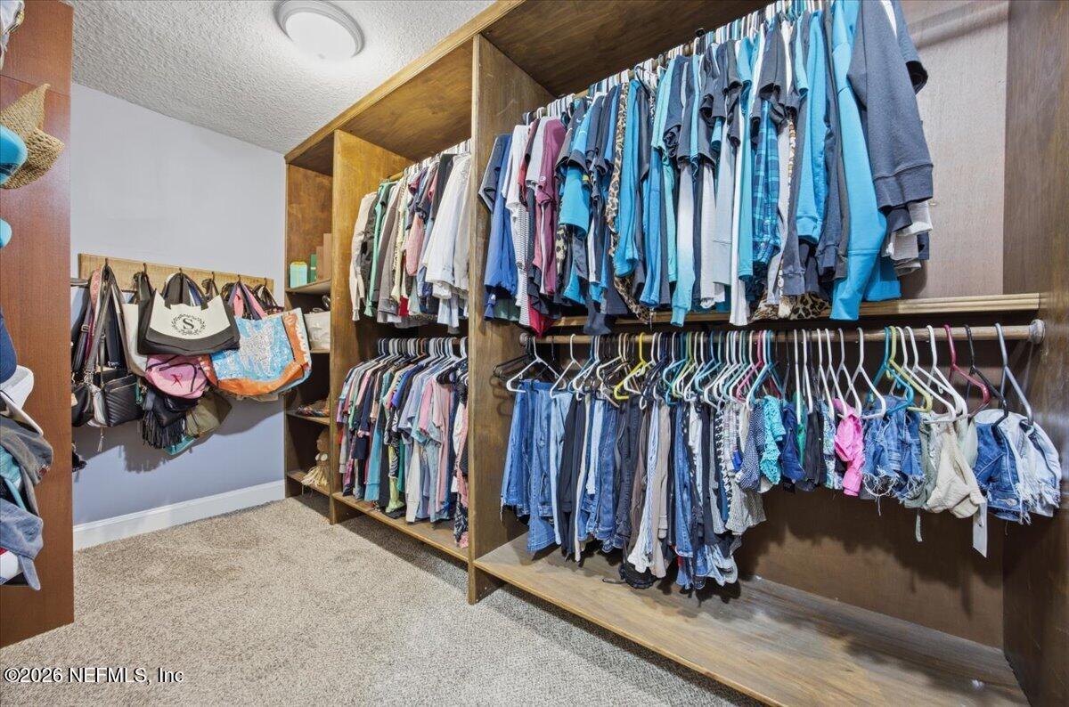 4009 Palm Way Jacksonville Beach, FL 32250 - Photo 17 of 24 a view of walk in closet with clothes
