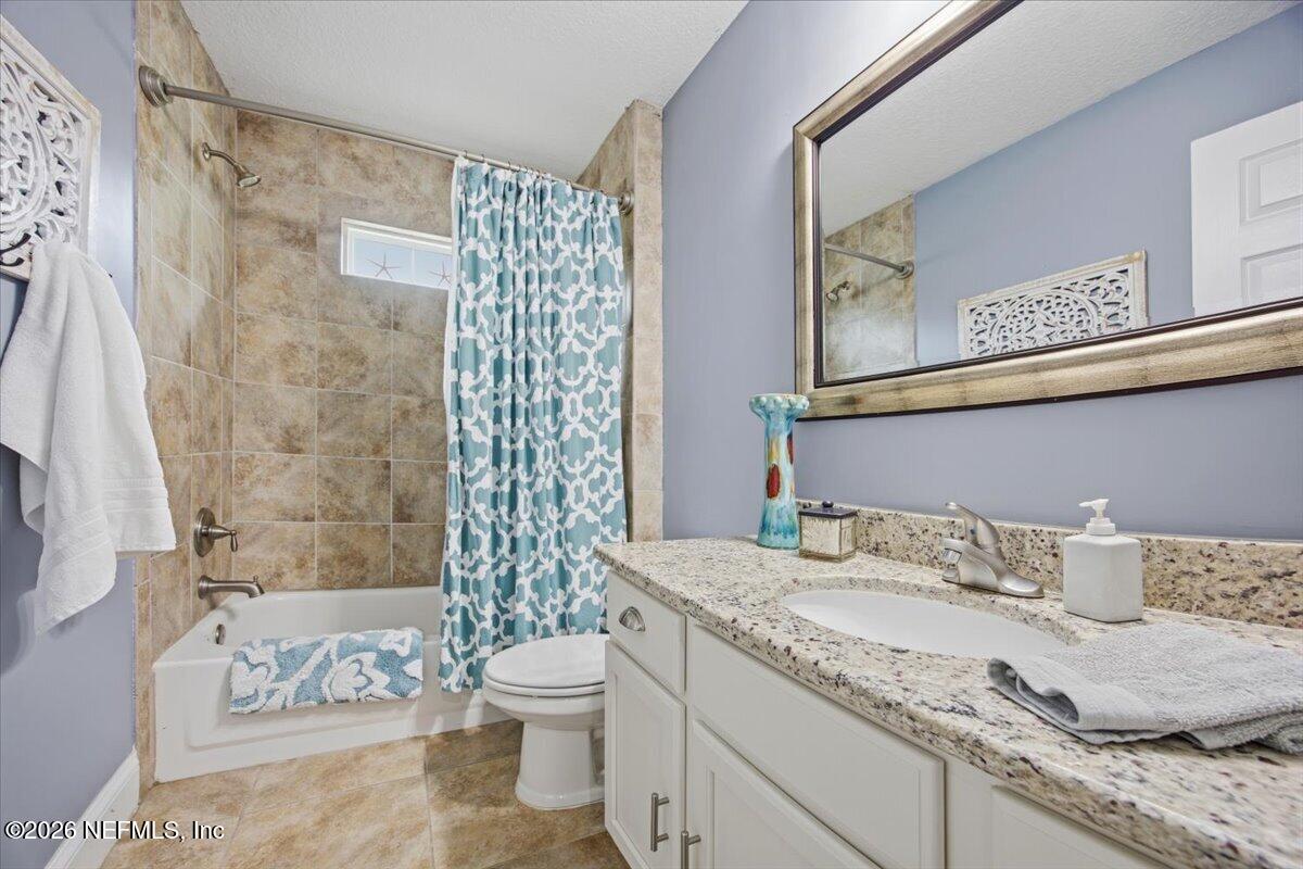 4009 Palm Way Jacksonville Beach, FL 32250 - Photo 20 of 24 a bathroom with a granite countertop sink and a mirror