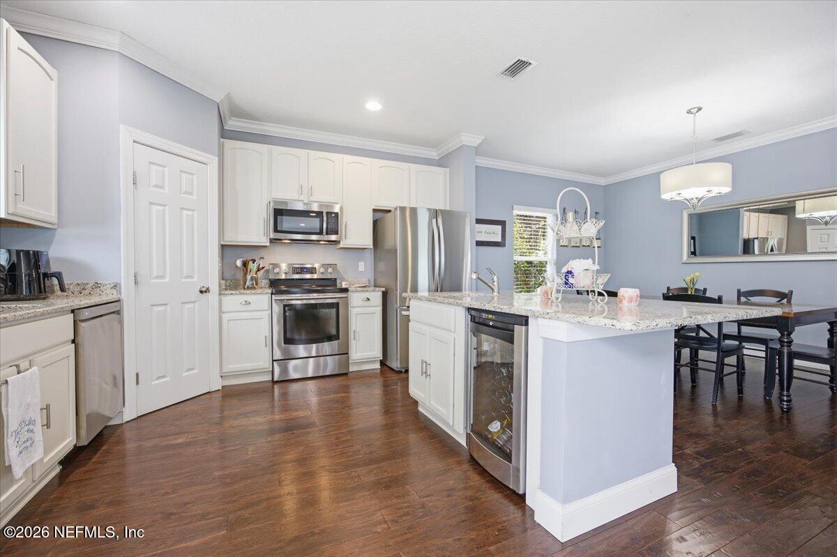 4009 Palm Way Jacksonville Beach, FL 32250 - Photo 7 of 24 a kitchen with a refrigerator cabinets and wooden floor