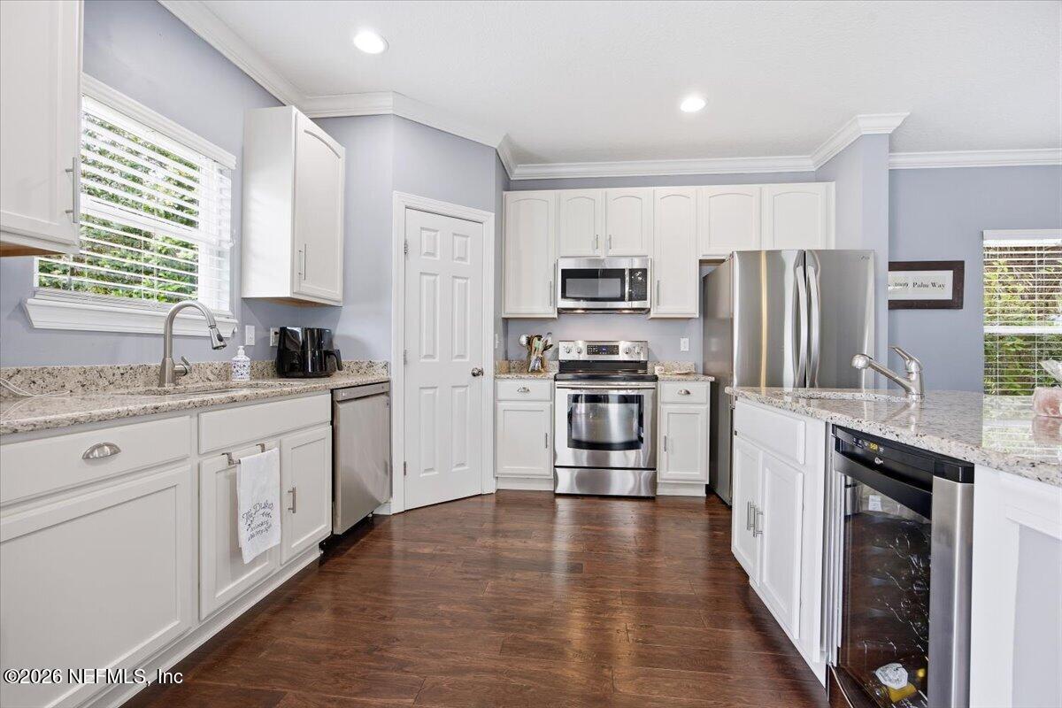 4009 Palm Way Jacksonville Beach, FL 32250 - Photo 8 of 24 a kitchen with kitchen island granite countertop a sink appliances cabinets and counter space