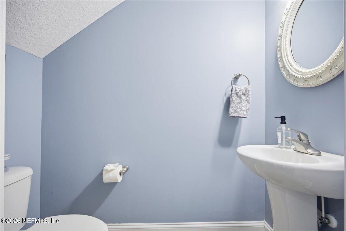 4009 Palm Way Jacksonville Beach, FL 32250 - Photo 10 of 24 a bathroom with a sink mirror and toilet