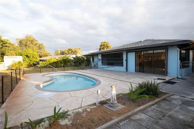 a view of a house with a backyard