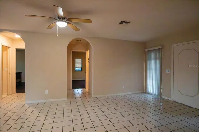 a view of a hallway with wooden floor and a chandelier