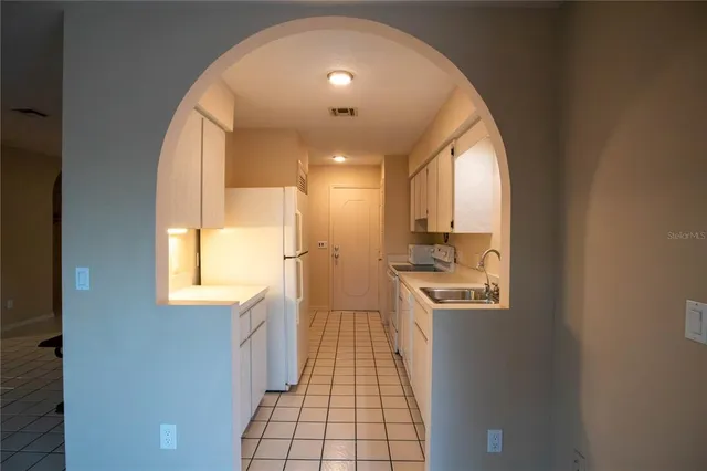 a view of a kitchen with a sink and windows