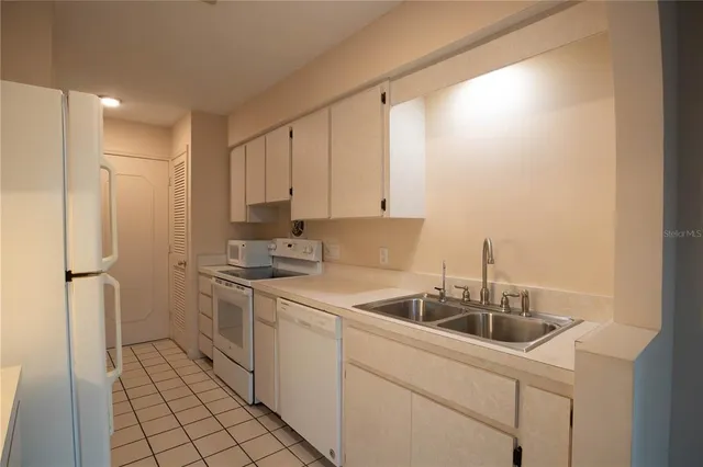 a kitchen with a sink cabinets and stainless steel appliances
