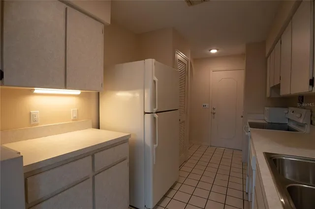 a kitchen with a sink appliances and cabinets