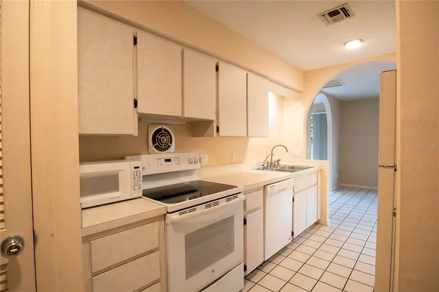 a view of a sink and a refrigerator in a room