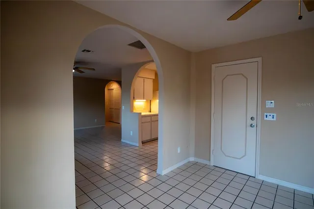 a view of a hallway with wooden shelves