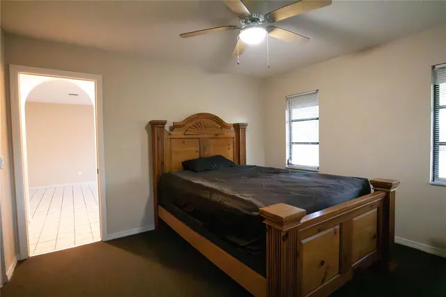 a room with pool table and windows