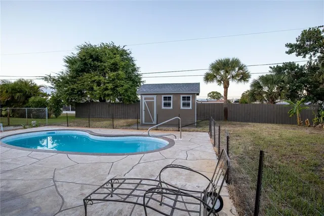 a swimming pool with outdoor seating yard and barbeque oven