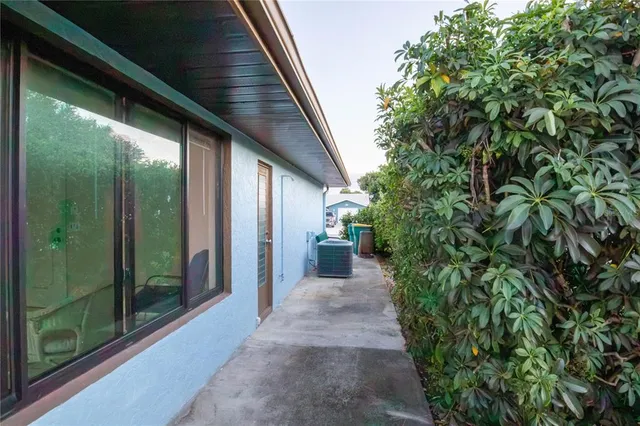 a view of a pathway both side of the house