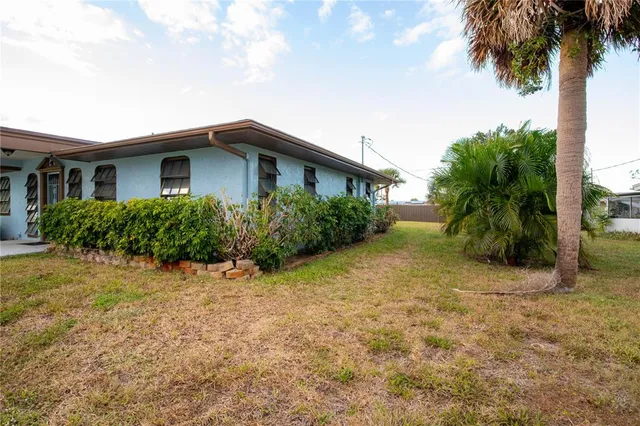 a yellow house with a tree in front of it
