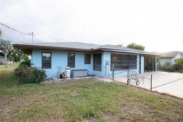 a view of a house with backyard sitting area and garden