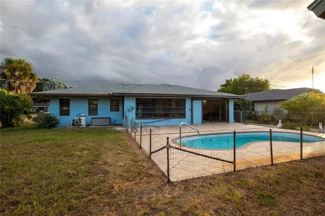 a view of house with backyard