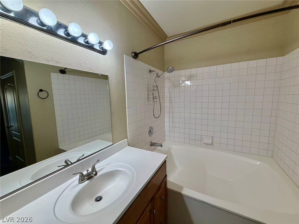 5525 West Flamingo Road, Unit 1019 Las Vegas, NV 89103 - Photo 18 of 18 A well-appointed bathroom features a single vanity, ample mirror, and a classic tub-shower combination.